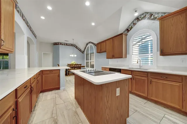 a kitchen that has a sink and a stove in it