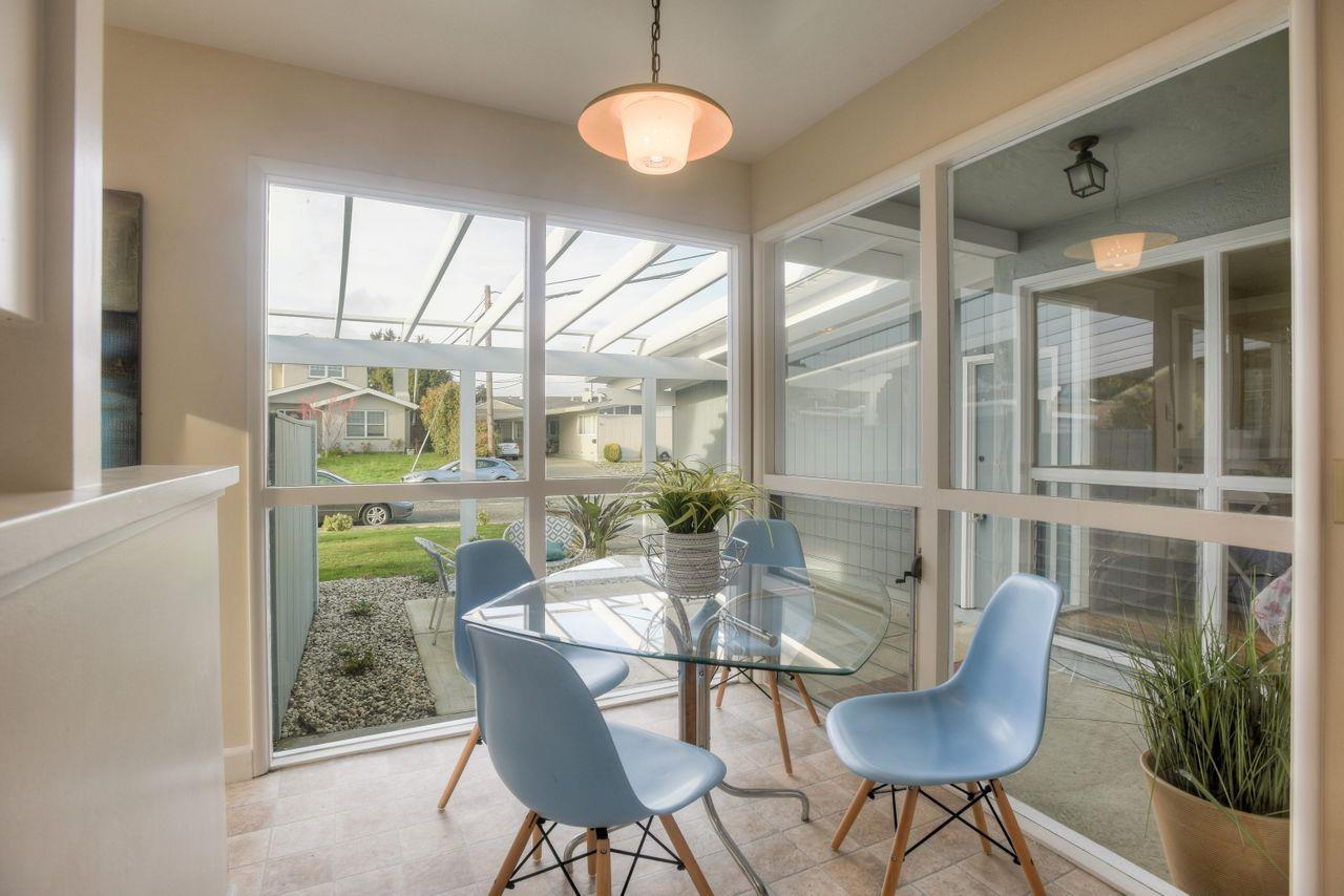 805 Robin Lane Millbrae, CA 94030 - Photo 11 of 23 a dining room with furniture wooden floor a potted plant and a chandelier