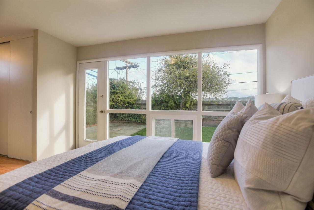 805 Robin Lane Millbrae, CA 94030 - Photo 13 of 23 a bed sitting in a bedroom next to a window