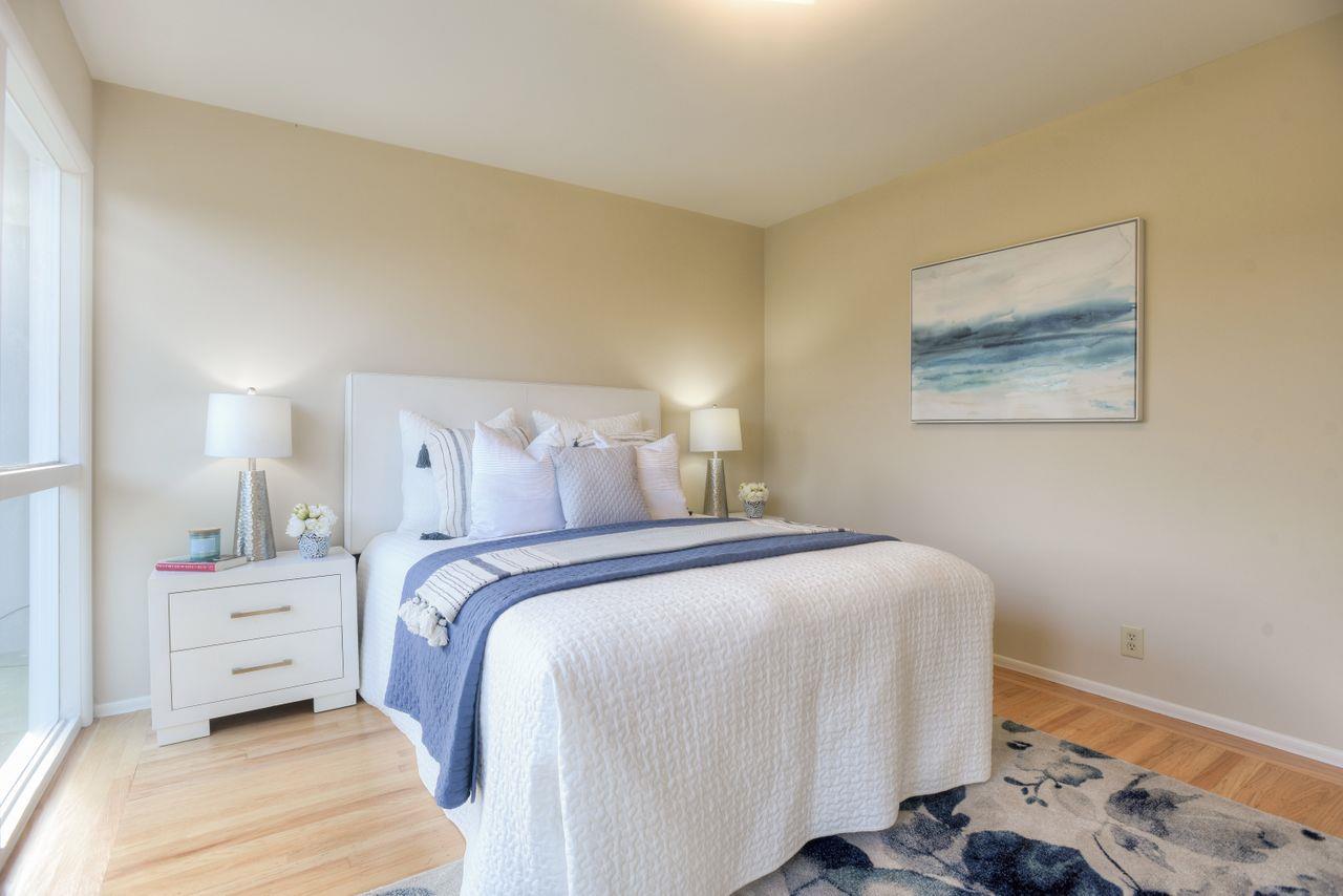 805 Robin Lane Millbrae, CA 94030 - Photo 14 of 23 a bedroom with a bed and a lamp on dresser
