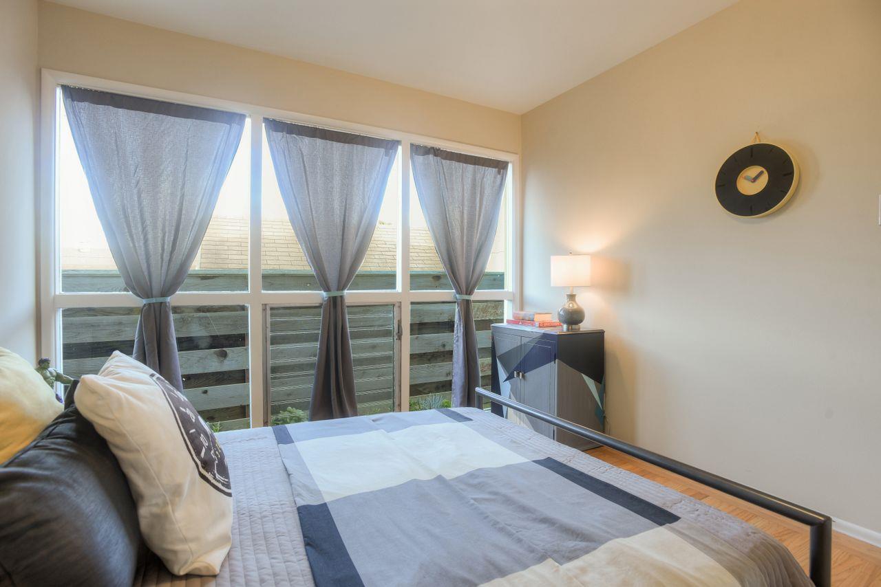 805 Robin Lane Millbrae, CA 94030 - Photo 18 of 23 a bedroom with a bed and a large window