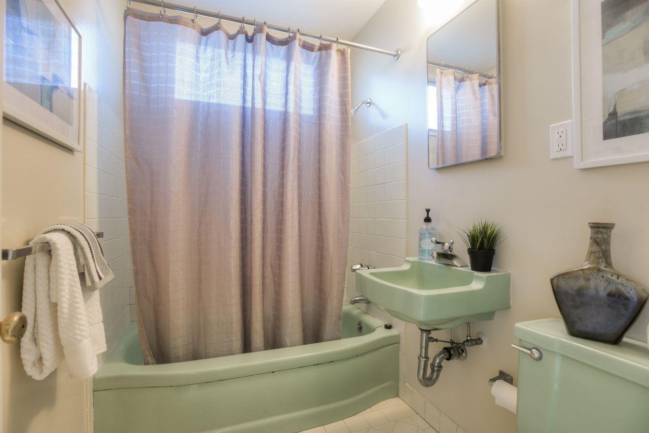 805 Robin Lane Millbrae, CA 94030 - Photo 21 of 23 a bathroom with a sink a toilet and mirror