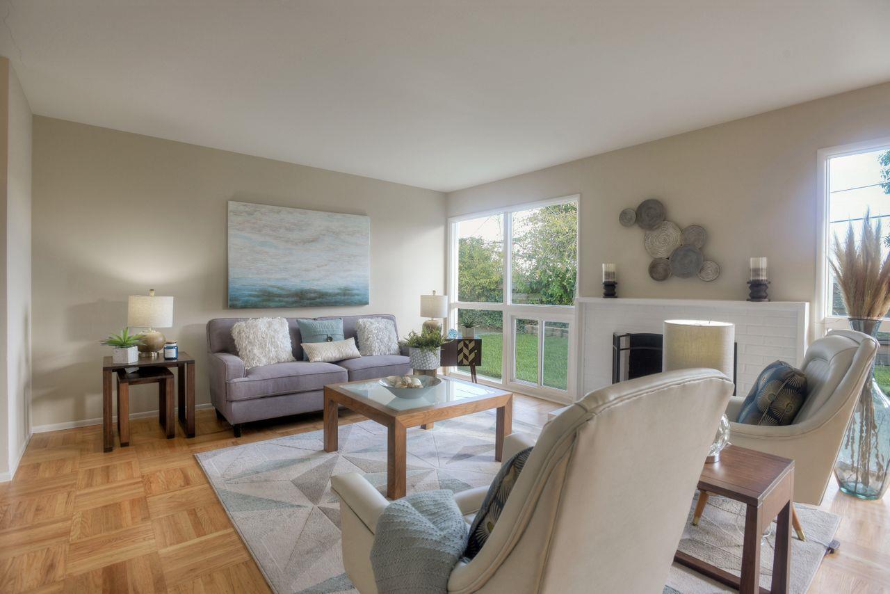 805 Robin Lane Millbrae, CA 94030 - Photo 6 of 23 a living room with furniture a fireplace and a floor to ceiling window