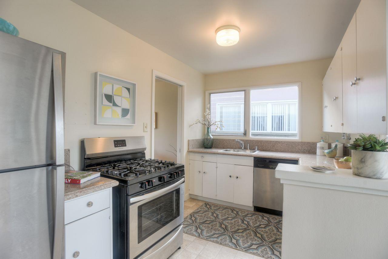 805 Robin Lane Millbrae, CA 94030 - Photo 9 of 23 a kitchen with stainless steel appliances a stove a sink and a refrigerator