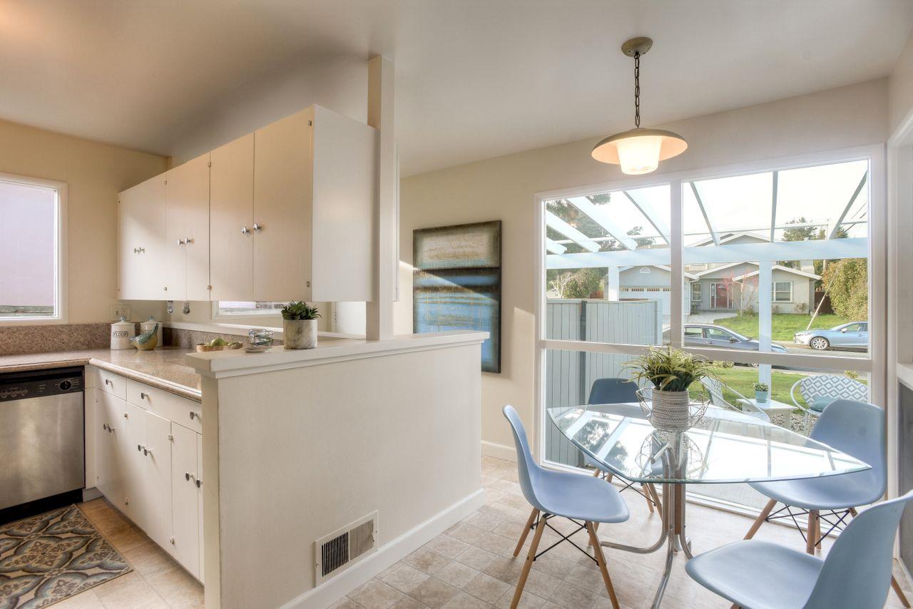 805 Robin Lane Millbrae, CA 94030 - Photo 10 of 23 a kitchen with stainless steel appliances kitchen island granite countertop a table and chairs in it