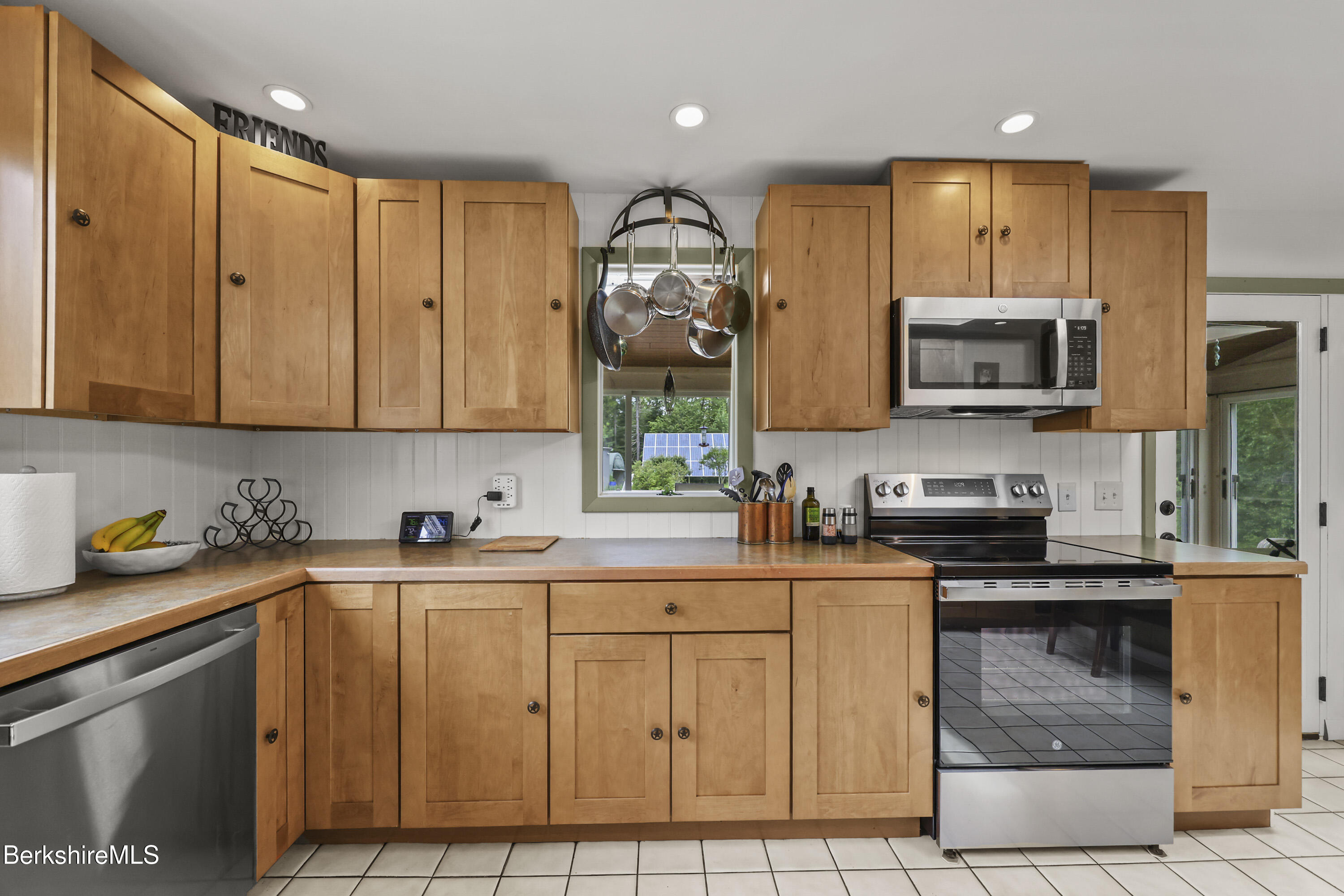 4 Birch Hill Road Peru, MA 01235 - Photo 23 of 76 a kitchen with stainless steel appliances granite countertop a stove a sink dishwasher and a microwave oven with granite countertops