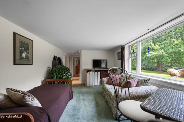 a swimming pool with an outdoor space and seating area