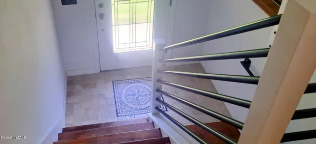 a living room with furniture fireplace and a large window