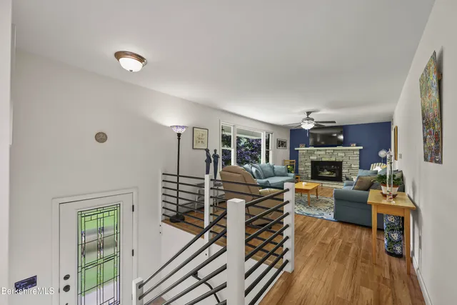 a living room with furniture a fireplace and a large window