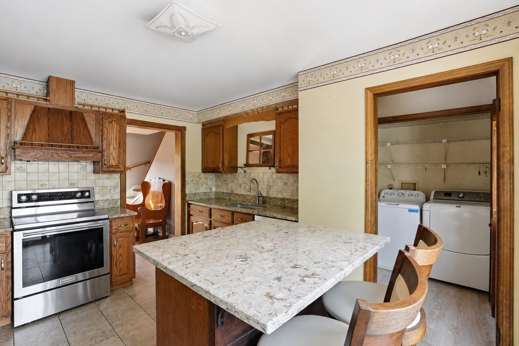 67 Wituwamat Road Weymouth, MA 02191 - Photo 12 of 42 a kitchen with a stove and a wooden floor