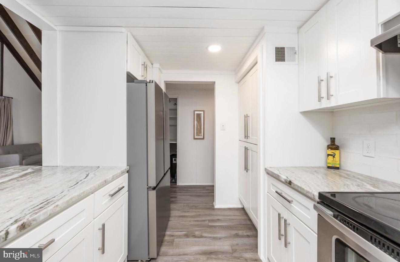 5 Falcon Bridge Road Ocean Pines, MD 21811 - Photo 19 of 59 a kitchen with a sink stove and refrigerator