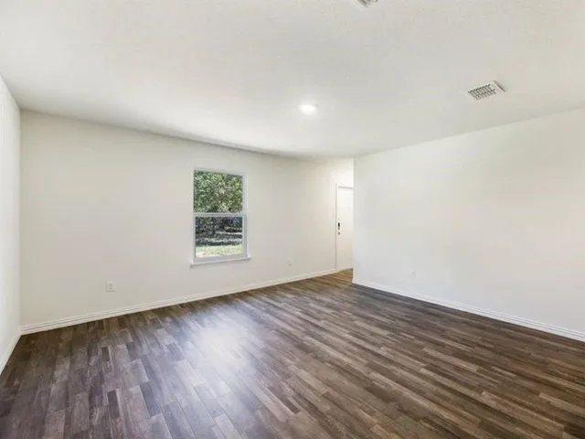 a view of kitchen with sink microwave and cabinets