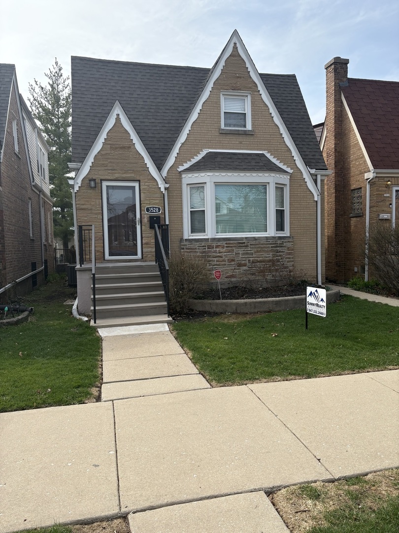 3528 North Neva Avenue Chicago, IL 60634 - Photo 1 of 37 a front view of a house with a yard