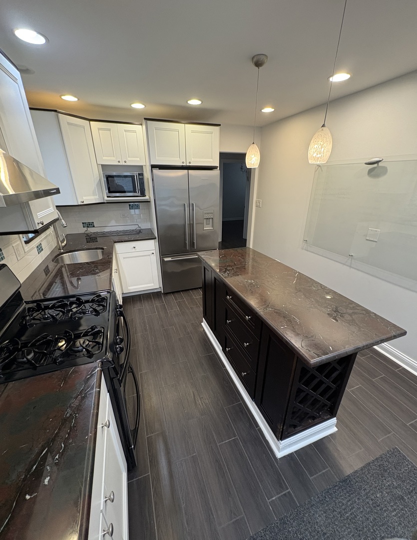 3528 North Neva Avenue Chicago, IL 60634 - Photo 12 of 37 a large kitchen with stainless steel appliances a large counter top