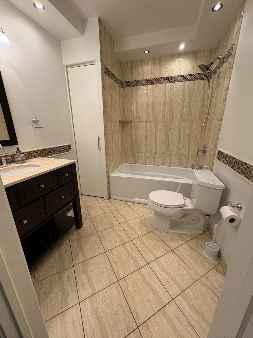 3528 North Neva Avenue Chicago, IL 60634 - Photo 13 of 37 a bathroom with a sink a toilet and a bathtub