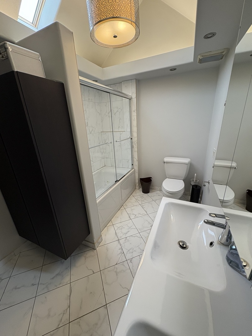 3528 North Neva Avenue Chicago, IL 60634 - Photo 18 of 37 a bathroom with a sink and a vanity