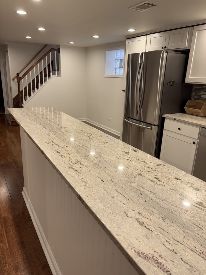 3528 North Neva Avenue Chicago, IL 60634 - Photo 24 of 37 a kitchen with stainless steel appliances a refrigerator and a counter top