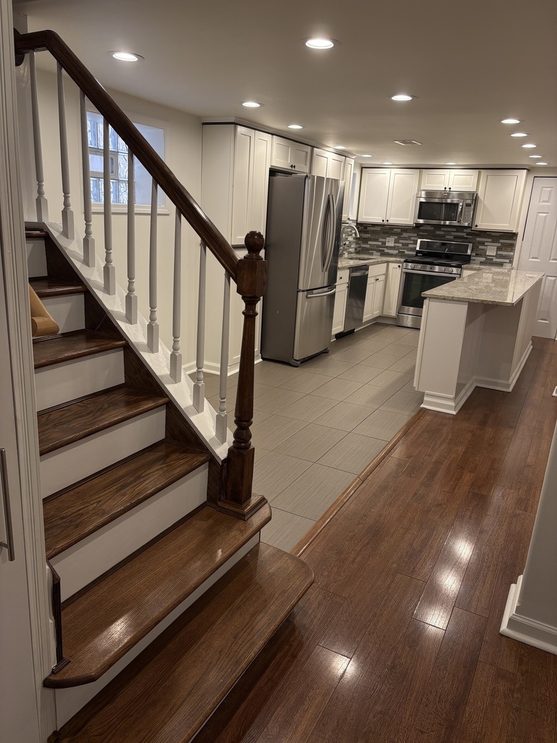3528 North Neva Avenue Chicago, IL 60634 - Photo 26 of 37 a view of kitchen with stainless steel appliances wooden floor and living room