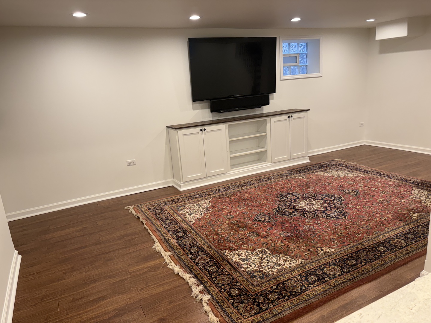 3528 North Neva Avenue Chicago, IL 60634 - Photo 27 of 37 a living room with a flat screen tv and a rug