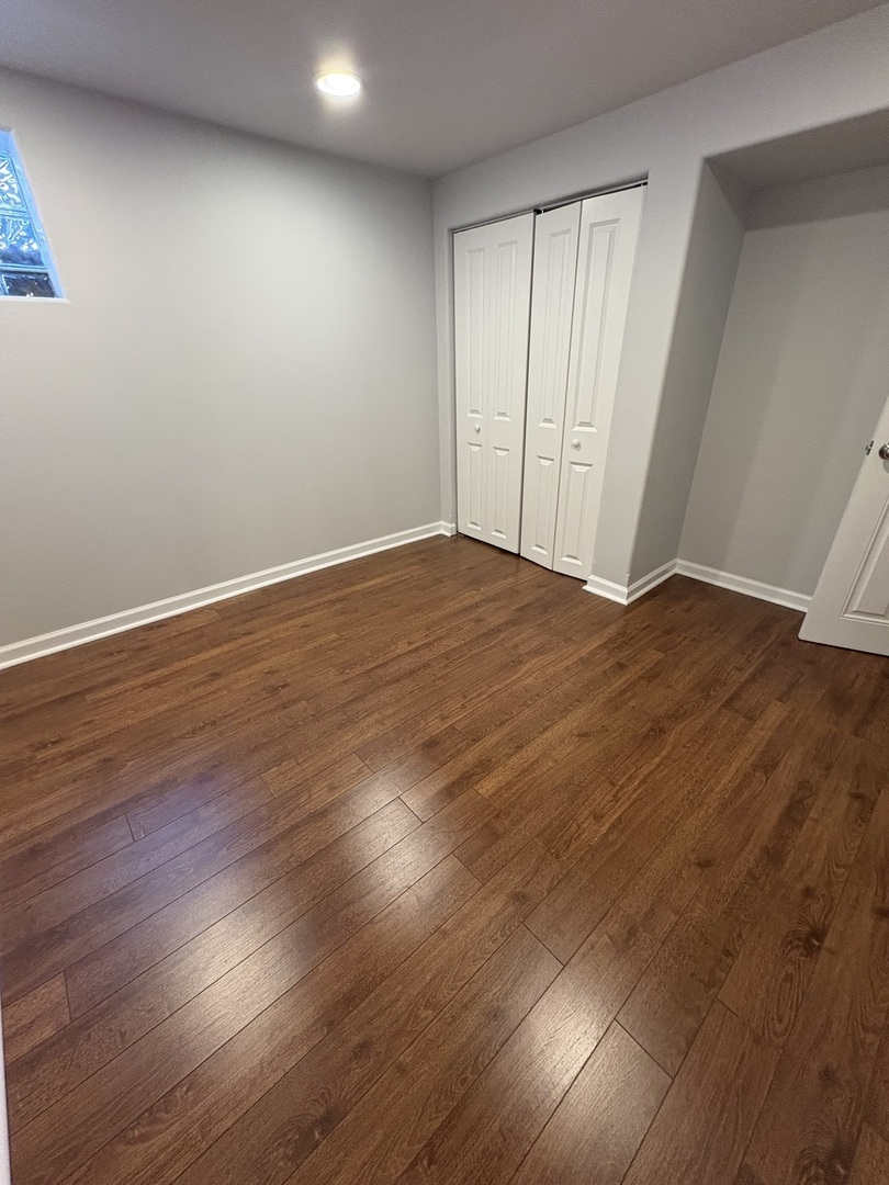 3528 North Neva Avenue Chicago, IL 60634 - Photo 29 of 37 an empty room with wooden floor and windows