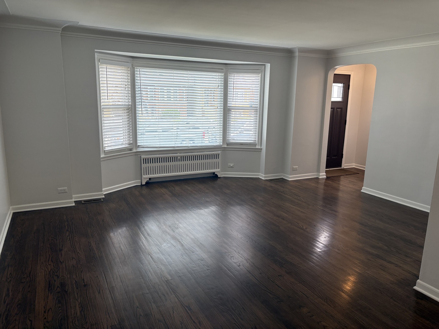 3528 North Neva Avenue Chicago, IL 60634 - Photo 3 of 37 an empty room with wooden floor and windows