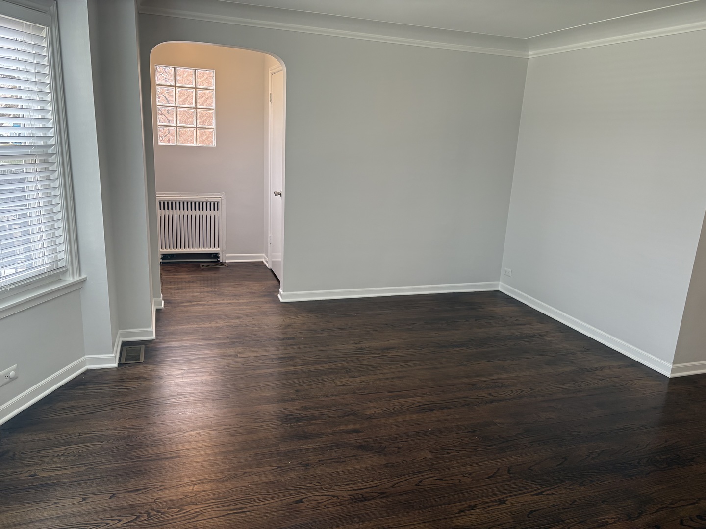 3528 North Neva Avenue Chicago, IL 60634 - Photo 4 of 37 an empty room with wooden floor and windows
