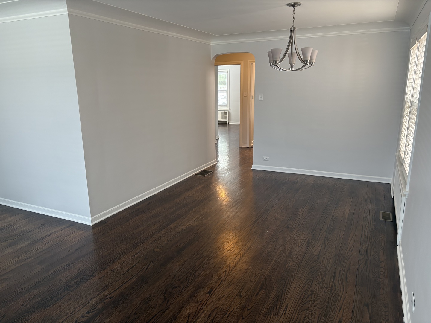 3528 North Neva Avenue Chicago, IL 60634 - Photo 5 of 37 a view of an empty room with wooden floor and a window