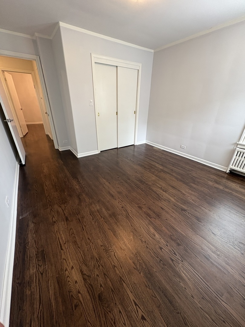 3528 North Neva Avenue Chicago, IL 60634 - Photo 6 of 37 a view of empty room with wooden floor and entryway