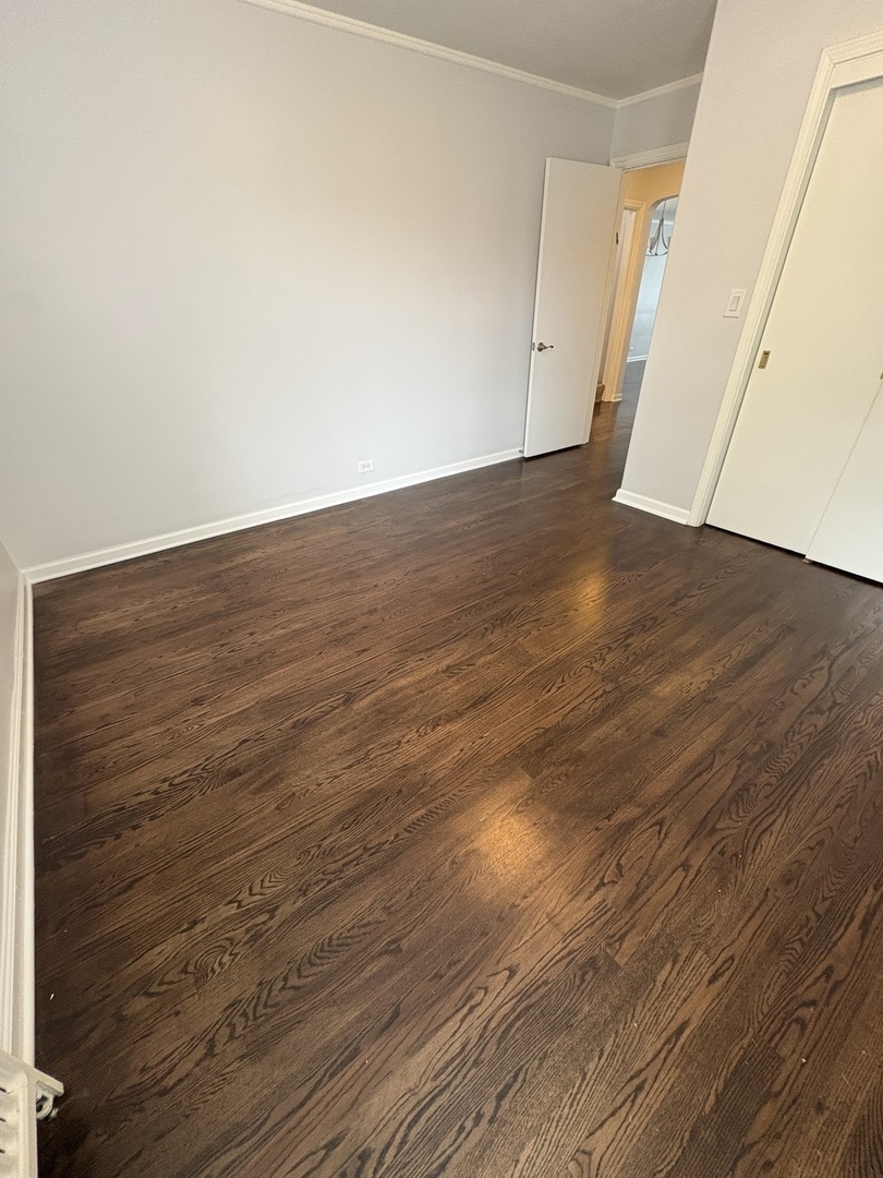 3528 North Neva Avenue Chicago, IL 60634 - Photo 7 of 37 a view of an empty room with wooden floor
