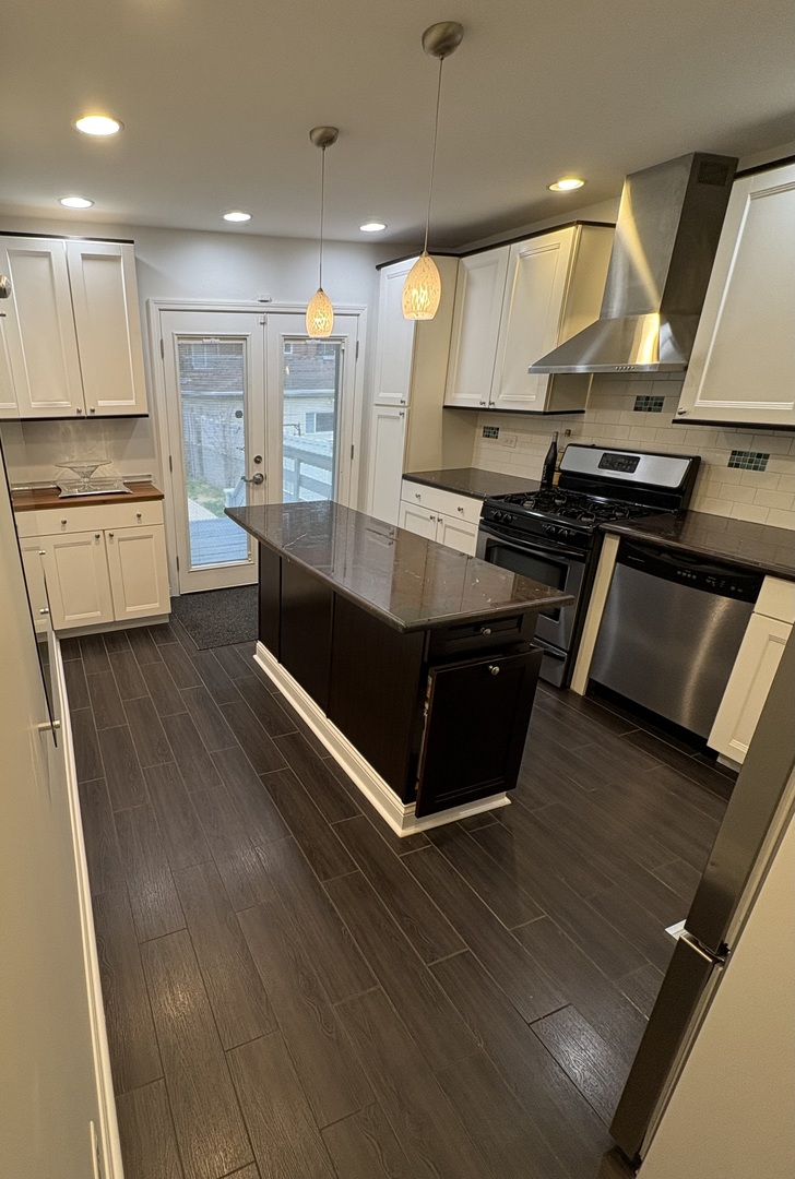 3528 North Neva Avenue Chicago, IL 60634 - Photo 10 of 37 a kitchen with stainless steel appliances granite countertop a stove and a sink