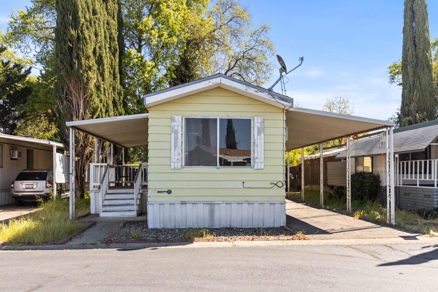 417 Westacre Road, Unit 22 West Sacramento, CA 95691 - Photo 2 of 4 a view of a house with a yard and garage
