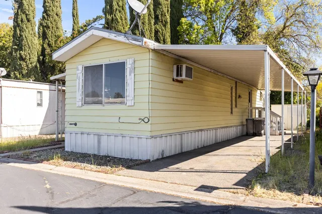 a view of a house with a wooden fence