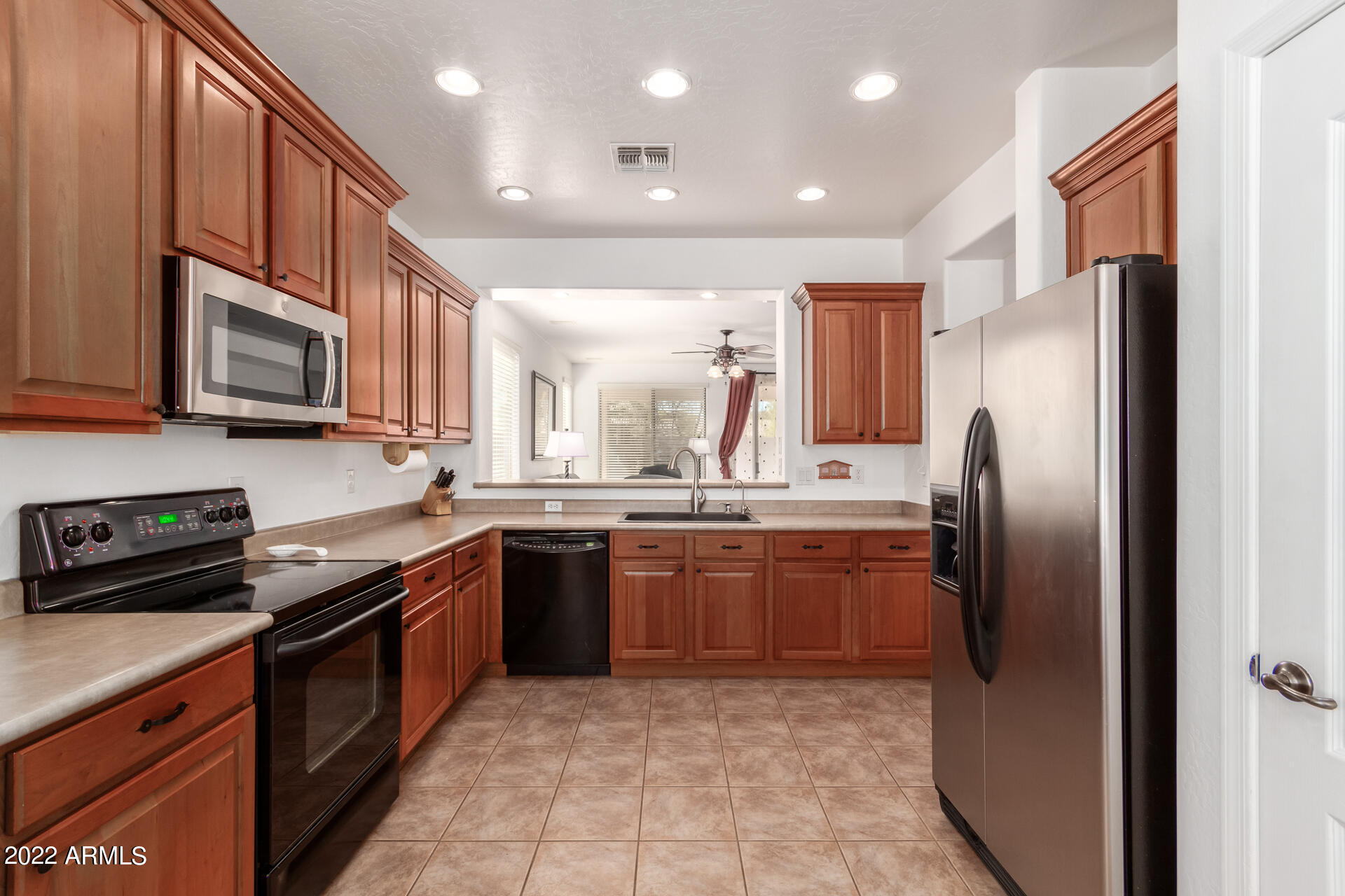 4723 East Timberline Road Gilbert, AZ 85297 - Photo 13 of 30 a kitchen with stainless steel appliances granite countertop a refrigerator a stove a sink a microwave and island