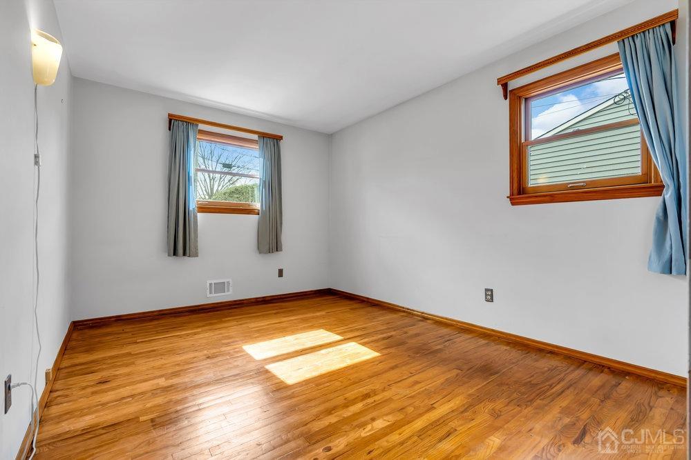 13 Eardley Road Edison, NJ 08817 - Photo 11 of 35 a view of a room with wooden floor and a window
