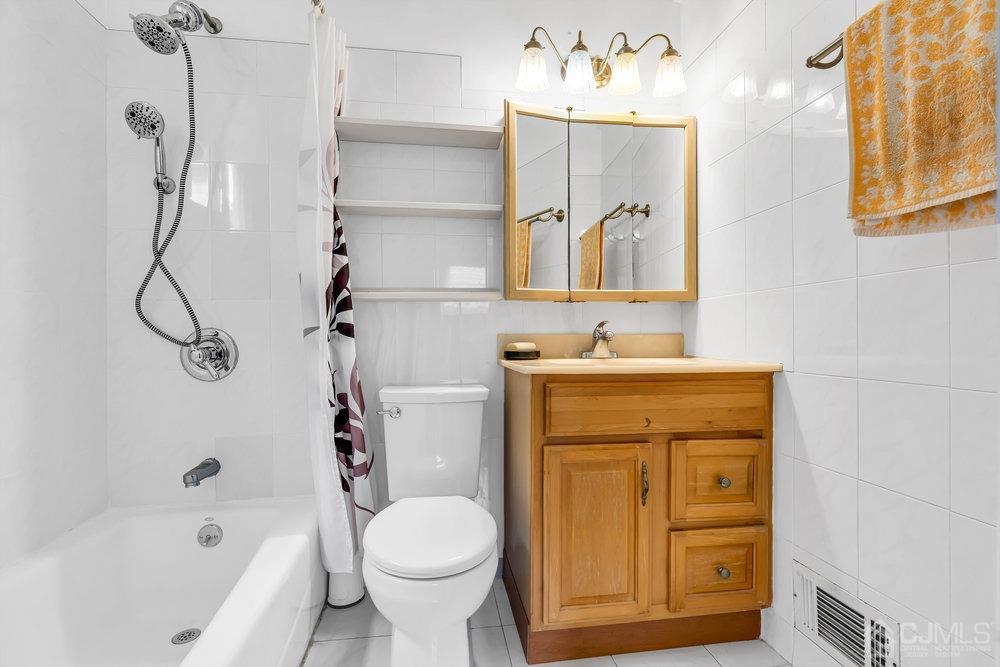 13 Eardley Road Edison, NJ 08817 - Photo 15 of 35 a bathroom with a sink mirror vanity and toilet