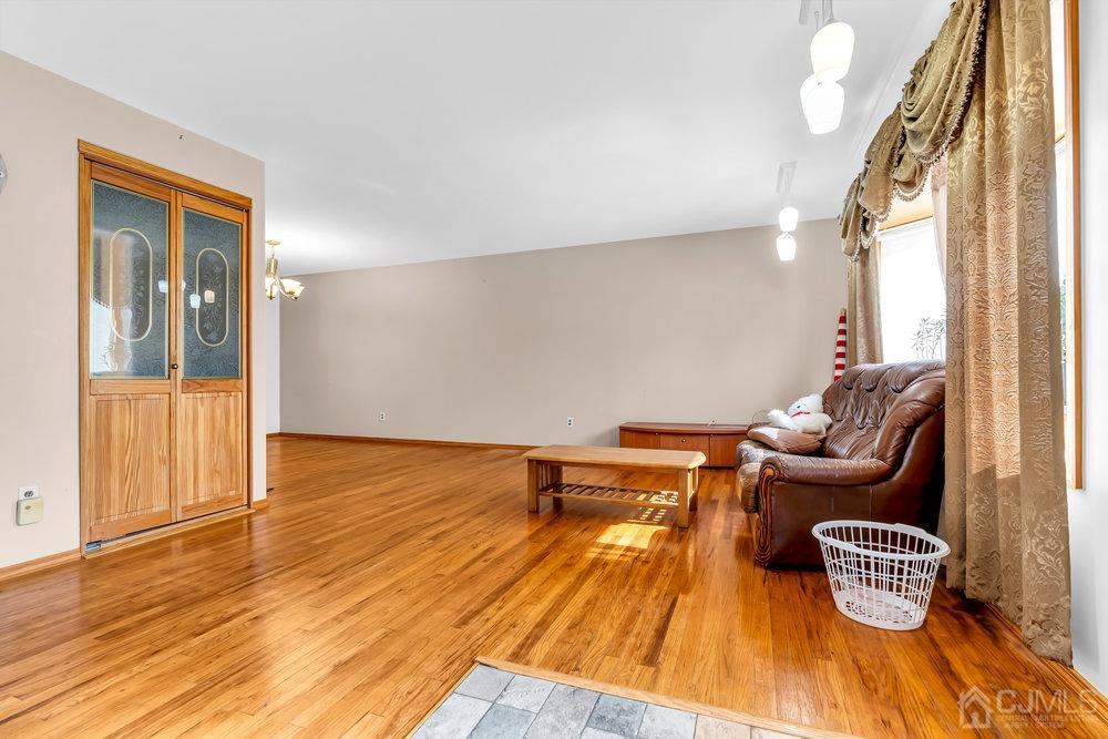 13 Eardley Road Edison, NJ 08817 - Photo 4 of 35 a living room with furniture and a wooden floor