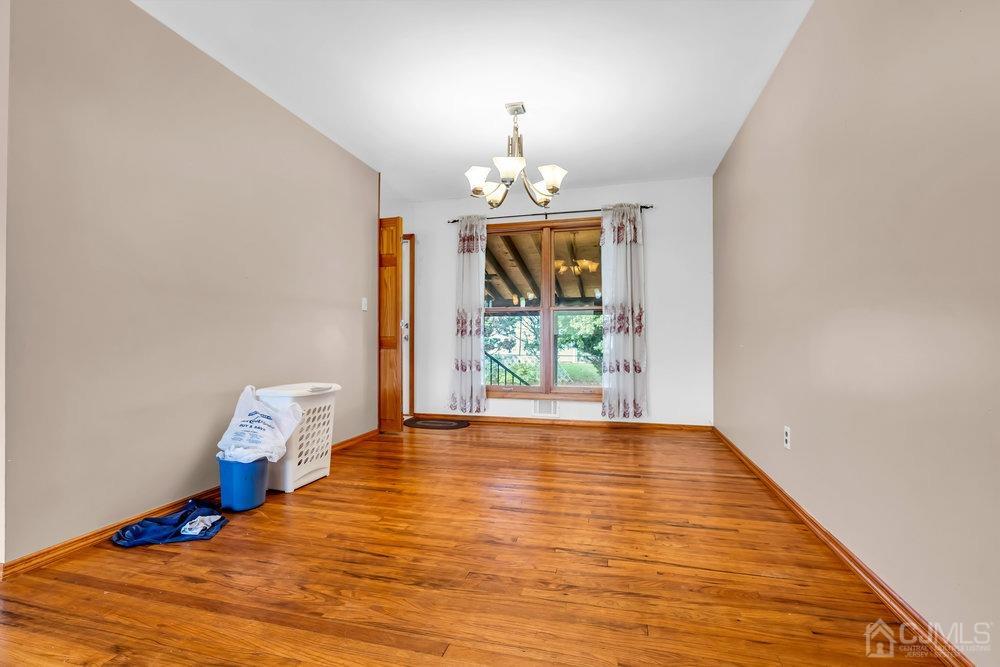 13 Eardley Road Edison, NJ 08817 - Photo 8 of 35 a view of a livingroom with wooden floor chandelier and entryway