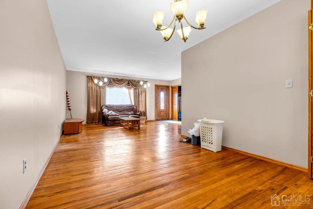 13 Eardley Road Edison, NJ 08817 - Photo 9 of 35 a view of a livingroom with wooden floor and a ceiling fan