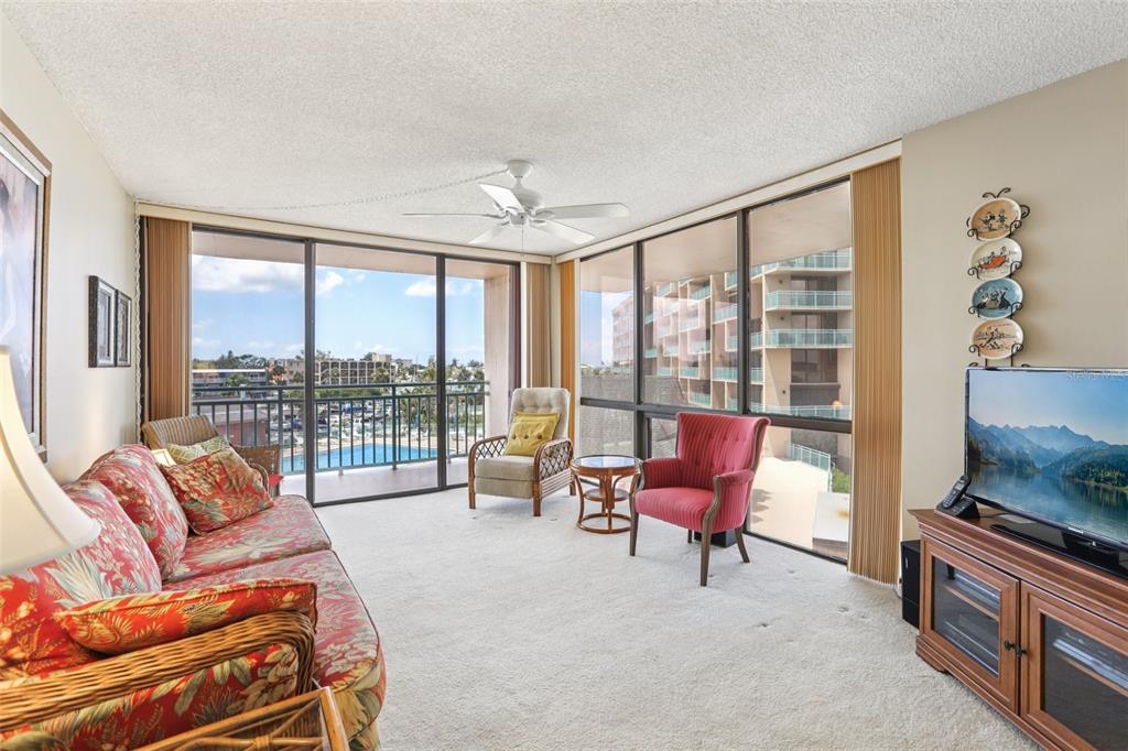1 Key Capri, Unit 302E Treasure Island, FL 33706 - Photo 13 of 29 a living room with furniture and a large window