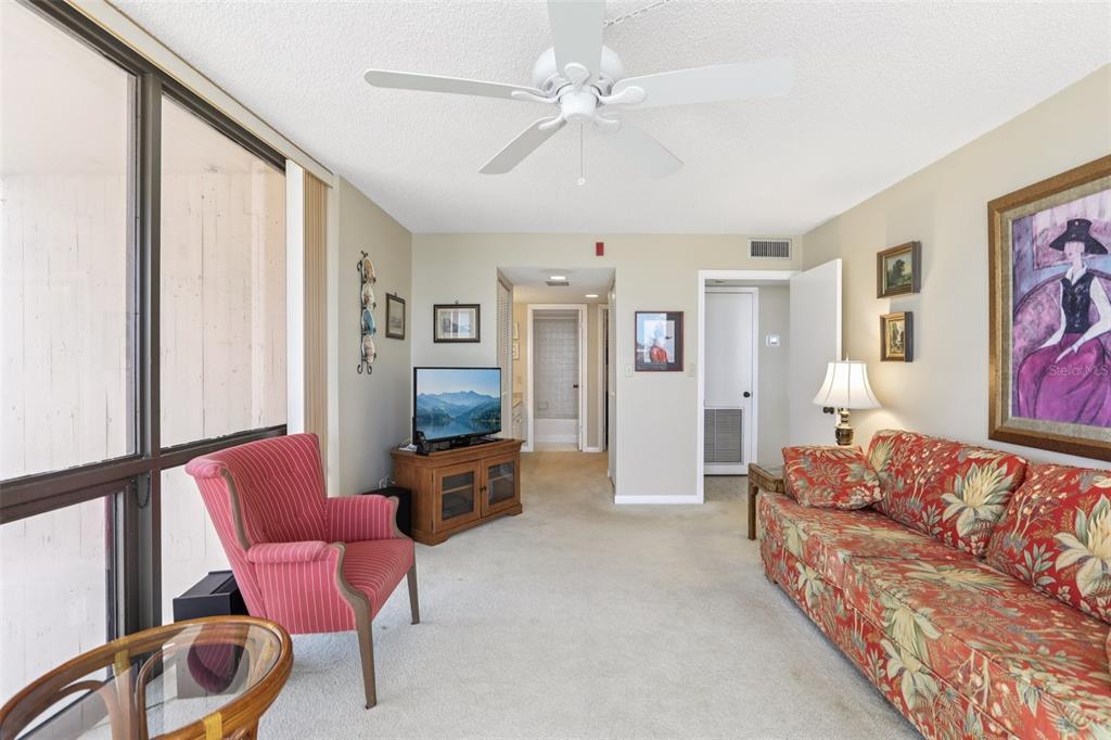 1 Key Capri, Unit 302E Treasure Island, FL 33706 - Photo 14 of 29 a living room with furniture and a flat screen tv