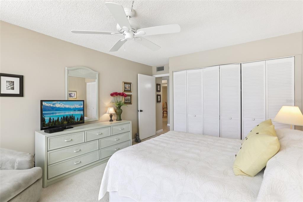 1 Key Capri, Unit 302E Treasure Island, FL 33706 - Photo 20 of 29 a bedroom with a bed and a dresser