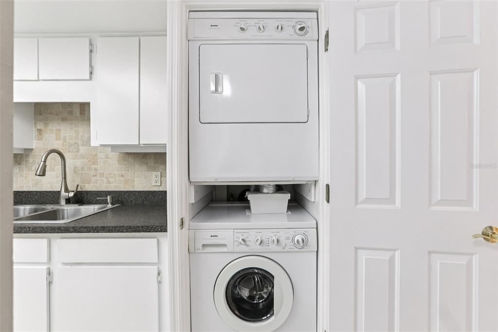 1 Key Capri, Unit 302E Treasure Island, FL 33706 - Photo 21 of 29 a close view of a sink and a washer dryer