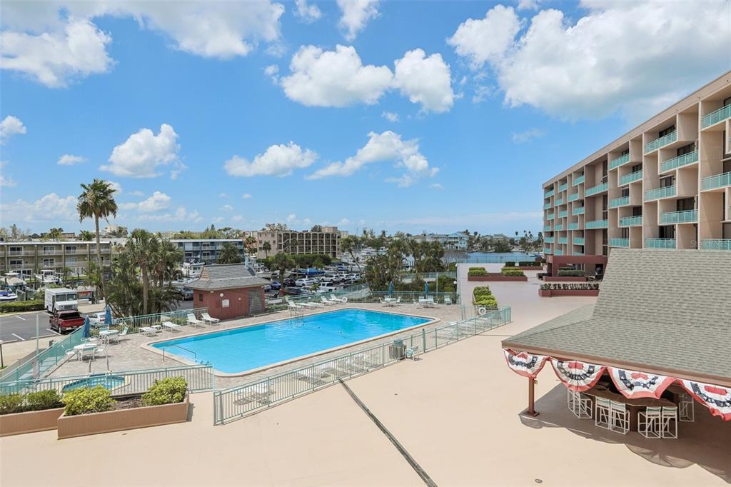 1 Key Capri, Unit 302E Treasure Island, FL 33706 - Photo 24 of 29 a view of a swimming pool with a lounge chairs