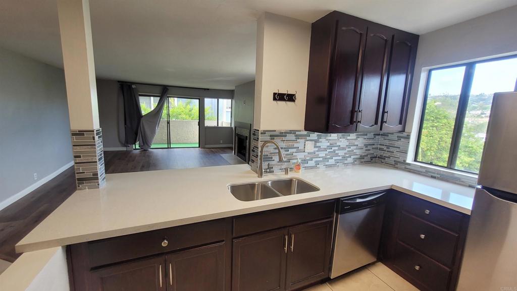 a kitchen with a sink and large window