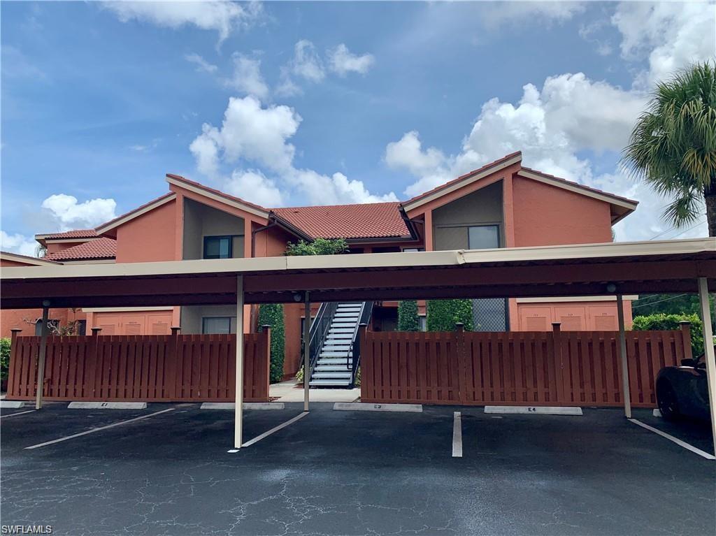 124 Cypress Way East, Unit E3 Naples, FL 34110 - Photo 1 of 22 a view of a house with a balcony