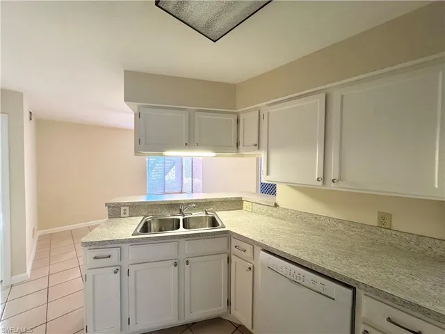 a kitchen with a sink cabinets and window