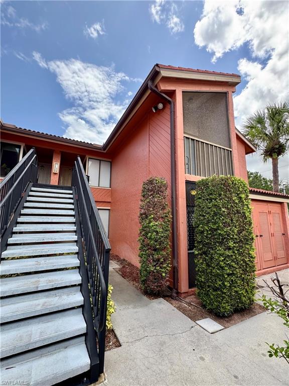 124 Cypress Way East, Unit E3 Naples, FL 34110 - Photo 18 of 22 a view of outdoor house and stairs