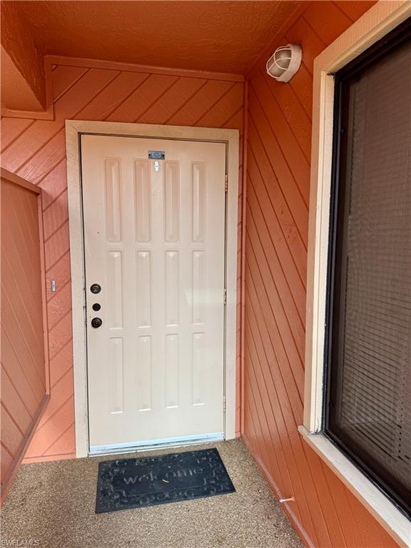 124 Cypress Way East, Unit E3 Naples, FL 34110 - Photo 19 of 22 a view of wooden door