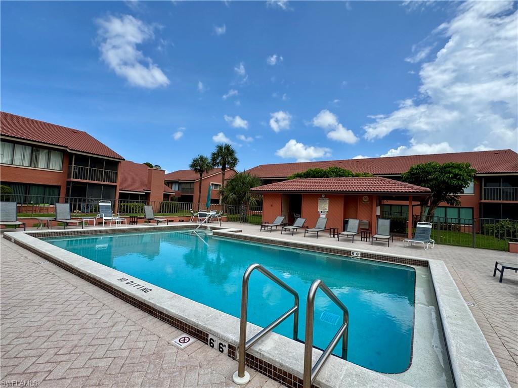 124 Cypress Way East, Unit E3 Naples, FL 34110 - Photo 22 of 22 a view of a swimming pool with a patio