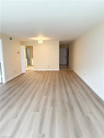 a view of an empty room and wooden floor
